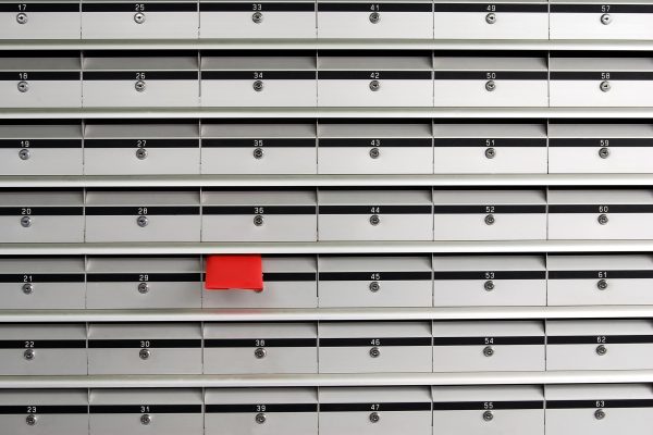 Letterboxes in rows with letter in red envelope